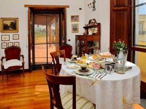 a dining room with a table with food on it at B&B Villa Elisa in Meta