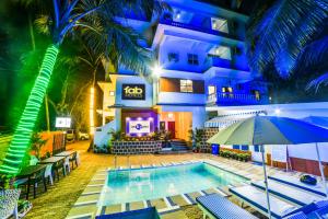 a hotel room with a pool and a balcony at FabHotel K7 Trends Baga in Calangute