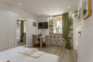 Zimmer mit einem Bett, einem Tisch und einem Fenster in der Unterkunft Split Center Apartments in Split