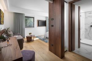 a living room with a sliding door leading to a bedroom at Hotel Milan in Pula