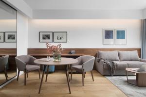 a living room with a table and a couch at Hotel Milan in Pula