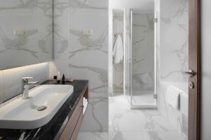 a bathroom with a sink and a shower at Hotel Milan in Pula