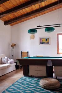 a living room with a pool table and a couch at Nômade - Slow Living Lodge in Balestrate