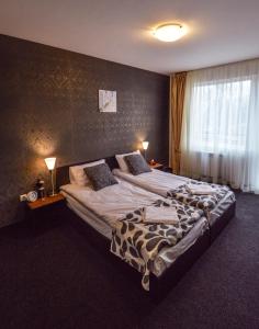 a hotel room with two beds and a window at Elite Spetema Hotel in Sofia