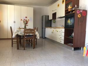 una cucina con tavolo e una cucina con frigorifero di Linda's home a Terzigno