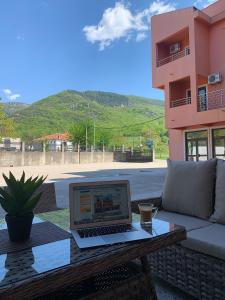 a laptop computer sitting on a table on a patio at Guesthouse Orlović in Budva