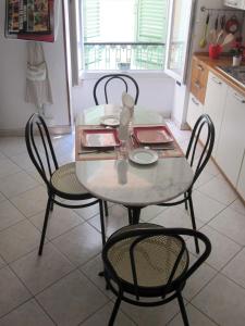 a table and four chairs in a kitchen at Studio Vieux Menton in Menton