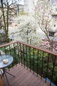 a balcony with a table and a tree with flowers at First Floor Flat in Ljubljana