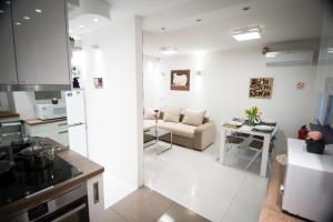 a kitchen and living room with a couch and a table at First Floor Flat in Ljubljana