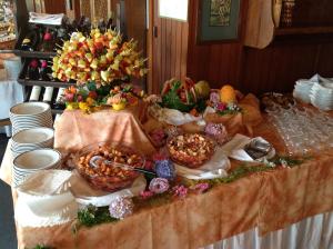 a table topped with bowls of food and flowers at Grand Hotel SIVA - Adults Only in Santo Stefano dʼAveto