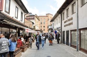 a group of people walking down a street at Apartments "Tuffo" in Sarajevo