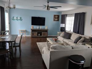 a living room with a couch and a table at Ashley Brooke Beach Resort in Deerfield Beach