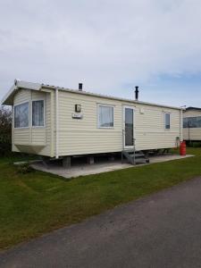a mobile home is parked on the side of a road at Caravan Willerby Rio in Looe