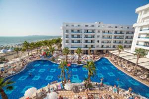 an overhead view of a hotel with a pool and the ocean at Fantasy Beach Apartment in Golem