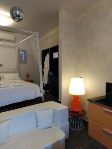 a bedroom with a bed and a table with a lamp at AMO Folegandros in Karavostasi