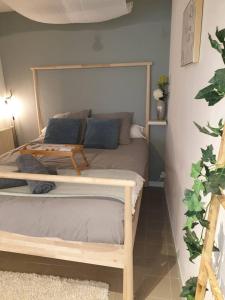 a bedroom with a bed with a table on it at Charmant Studio à Colombages in Morlaix