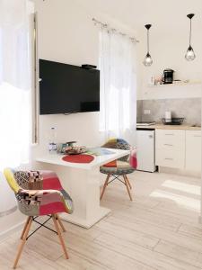 
a kitchen with a table and chairs and a refrigerator at Vila Siega in Zadar
