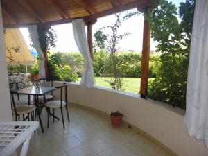 a patio with a table and chairs and a window at Oruci Apartments in Ksamil
