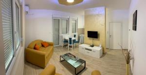 a living room with a couch and a tv at Airport view Apartment in Belgrade