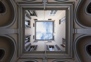 a room with a large window in a building at Appartamento affrescato 180mq in palazzo del 600 a Mantova in Mantova