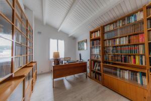 an office with two large book shelves filled with books at Villa des Jaulaines, Villa en bord de mer - Ile de Ré in Sainte-Marie-de-Ré
