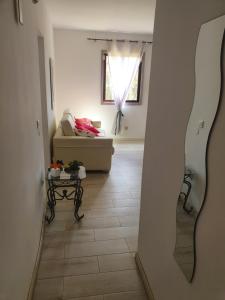 a hallway with a living room with a couch and a table at casa penelope in Costa Del Silencio +11 photos