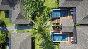 an overhead view of a resort with swimming pools and a palm tree at CHUZ Villas Samui SHA Plus in Lamai