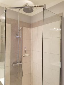 a shower with a glass door in a bathroom at CapSexy Port Nature Marina Naturist Village in Cap d'Agde