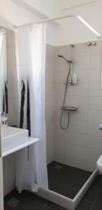 a white bathroom with a shower and a sink at Kamara rooms in Naousa in Naousa +27 photos
