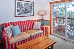 a living room with a couch and a table at Evergreen Lodge at Yosemite in Groveland