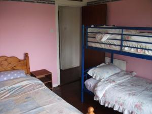 a bedroom with two bunk beds and a bed at Dry Harbour in Enniskillen