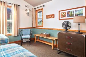 a bedroom with a bed and a desk and a chair at Evergreen Lodge at Yosemite in Groveland