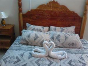 two towels in the shape of hearts on a bed at Chill on the Hill in Ocho Rios
