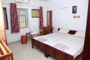 En eller flere senge i et værelse på Ocean Green Kerala