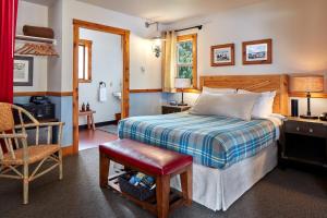 a bedroom with a bed and a desk and a chair at Evergreen Lodge at Yosemite in Groveland