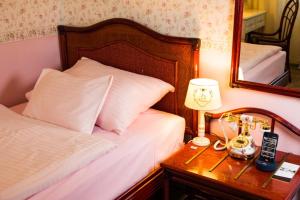 Postel nebo postele na pokoji v ubytování Hotel Freizeittempel