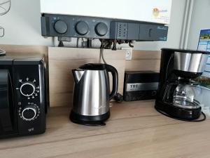 a kitchen counter with a coffee maker and a microwave at L'ENTRE 2 COTES in Le Tréport