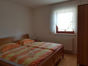 A bed or beds in a room at Vaznik Farm House Apartments