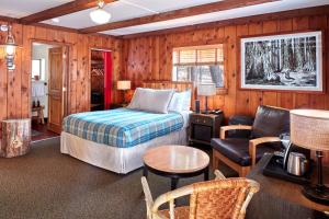 a bedroom with a bed and a living room at Evergreen Lodge at Yosemite in Groveland