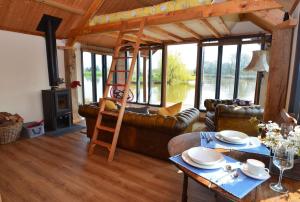 a living room with a loft bed and a couch at The Lake House @ Langford Court in Cullompton
