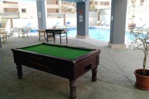 a pool table sitting in the middle of a patio at Palm Beach 8th - La Carihuela in Torremolinos