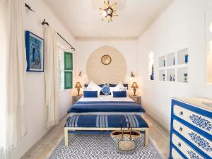 a bedroom with two beds and a chandelier at Riad Passali in Marrakesh