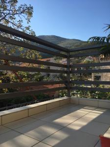 a large wooden pergola on top of a patio at Apartment Iva in Trebinje