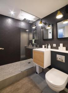 a bathroom with a toilet and a sink and a shower at Appartement Cocoon Hypercentre in Strasbourg +14 photos