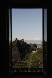 a window looking out at a view of the mountains at Oasi Di Cavoretto in Turin