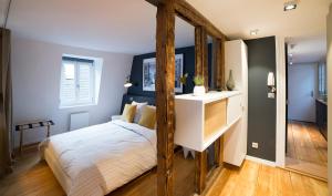 a bedroom with a bed with a wooden frame at Appartement Cocoon Hypercentre in Strasbourg