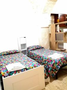 a bedroom with a bed and a table with a drawer at Casa Nino in Martina Franca