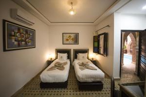 Postel nebo postele na pokoji v ubytování Riad Challa Hotel & Spa