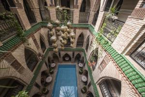 an overhead view of a building with a swimming pool at Riad Challa Hotel & Spa in Marrakesh