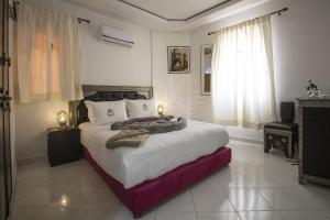 a bedroom with a large bed in a room at Riad Challa Hotel & Spa in Marrakesh +37 photos